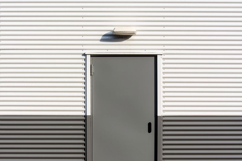 Garage door opener being installed on a garage ceiling